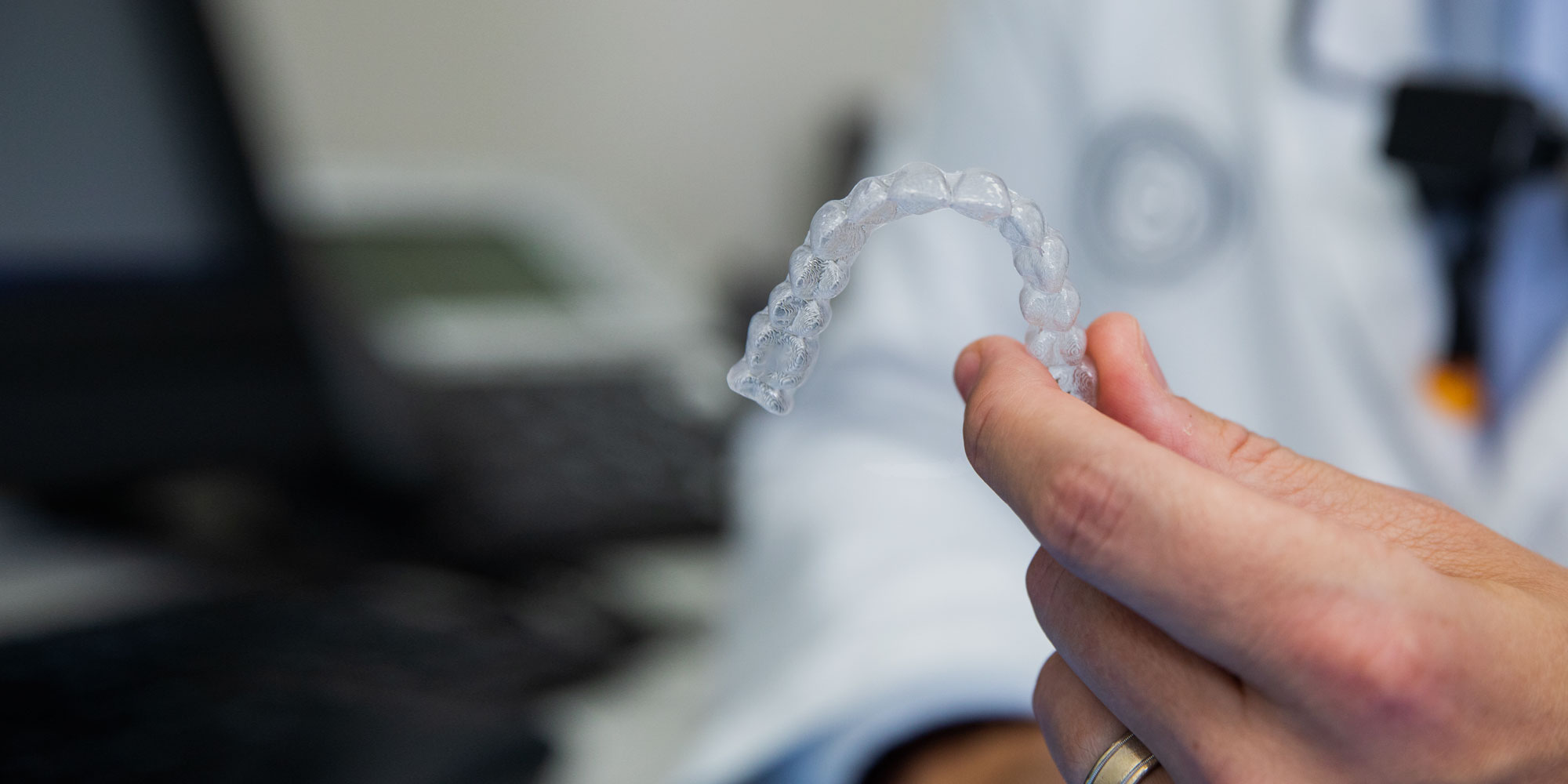 orthodontic aligner being held by dentist